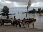 Click to enlarge pulling the double canoe out of Hilo Bay